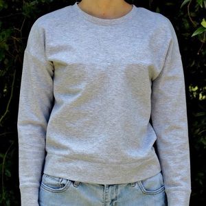 Gray pull over sweater with stitching on front